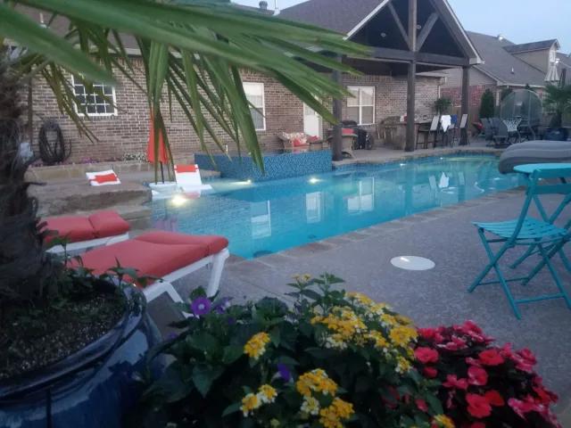 Swimming pool at night with lights in the pool - Diamond Pools AR
